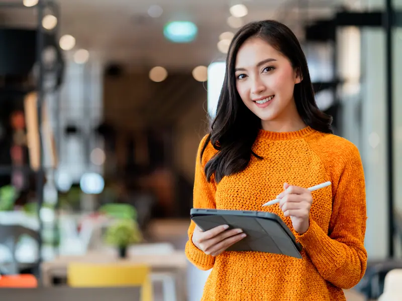 A business owner checking stock on a tablet in her showroom